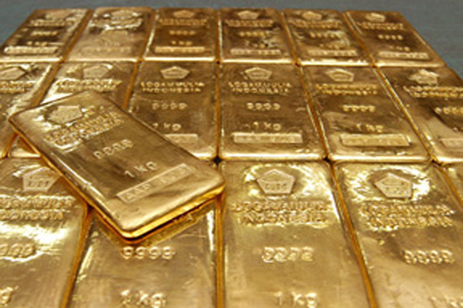 Gold biscuits lie on a table before smelting at manufacturing unit of 'Tanishq'