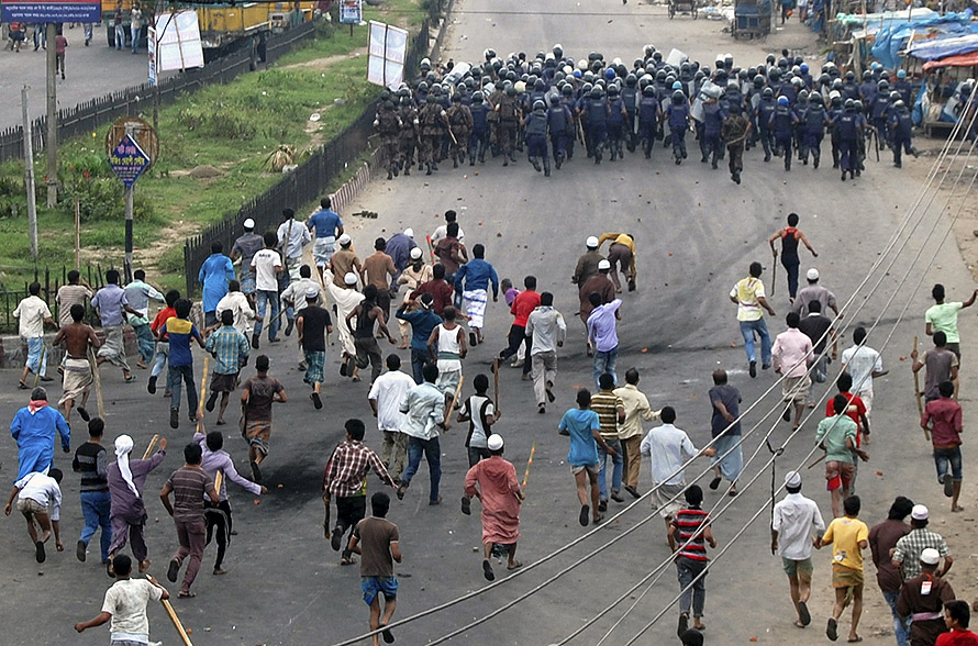Activists of Hefajat-e Islam chase police officers during a clash in Narayanganj